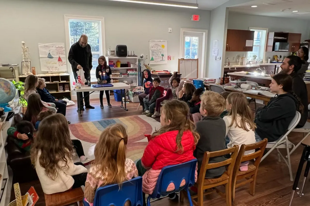 Children and teacher in a circle lesson inside the classroom