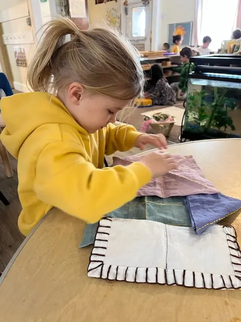 Child practicing Montessori folding work
